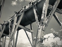 a black and white photo of a rusted pipe